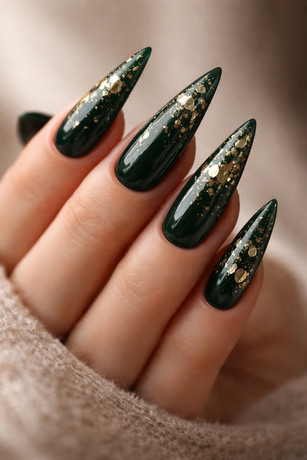 Forest green nails with scattered gold leaf flecks