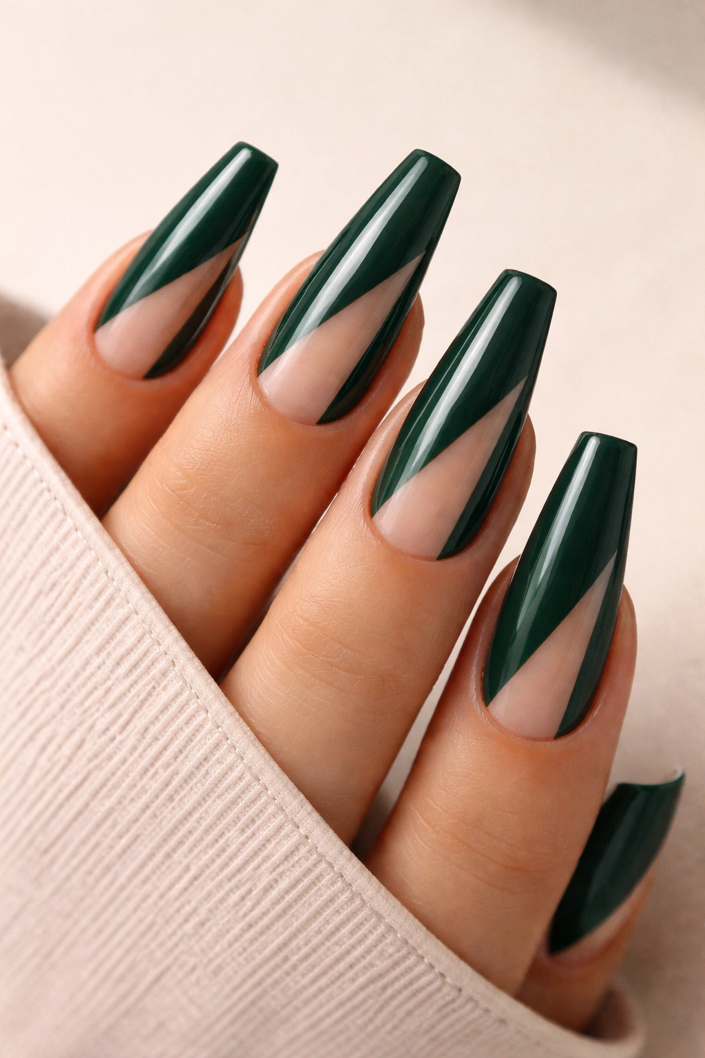 Close-up of forest green coffin nails with minimalist negative-space geometric cutouts