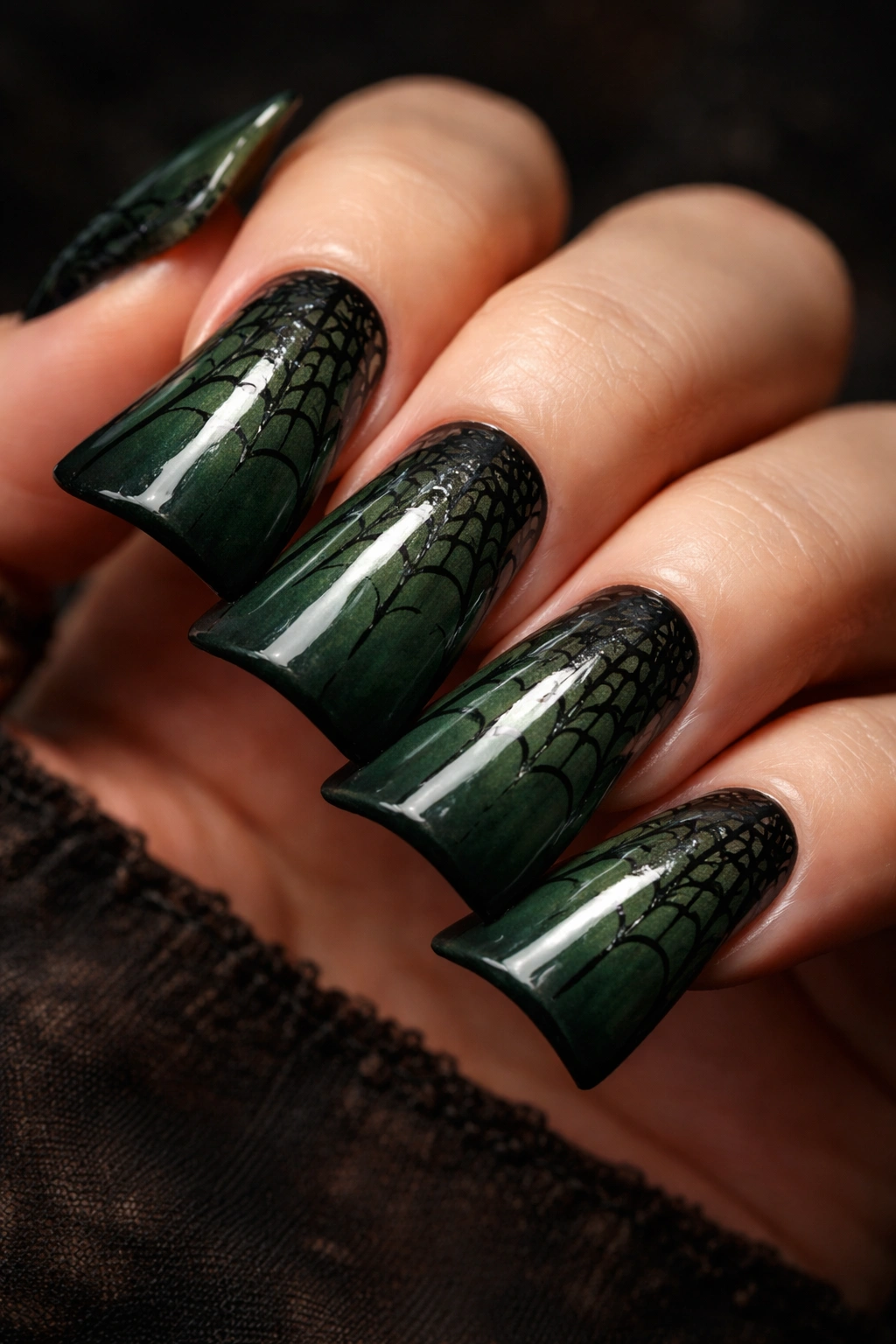 Duck nails in forest green with black spiderweb details.