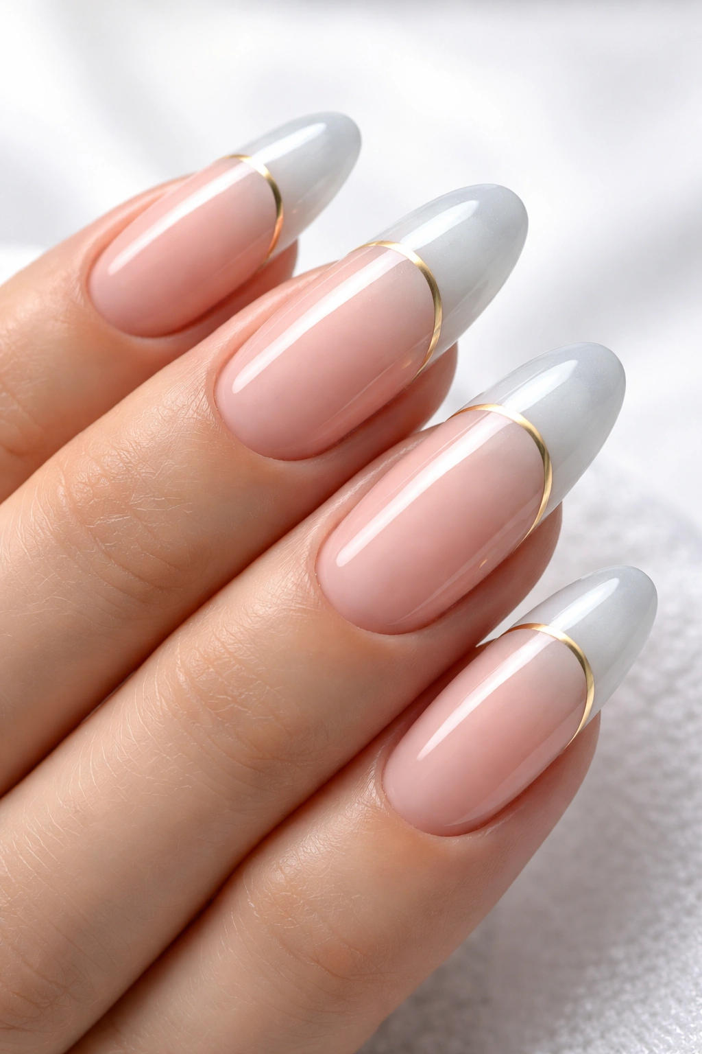 Long round nails with modern twist French manicure featuring pink base and gold stripe