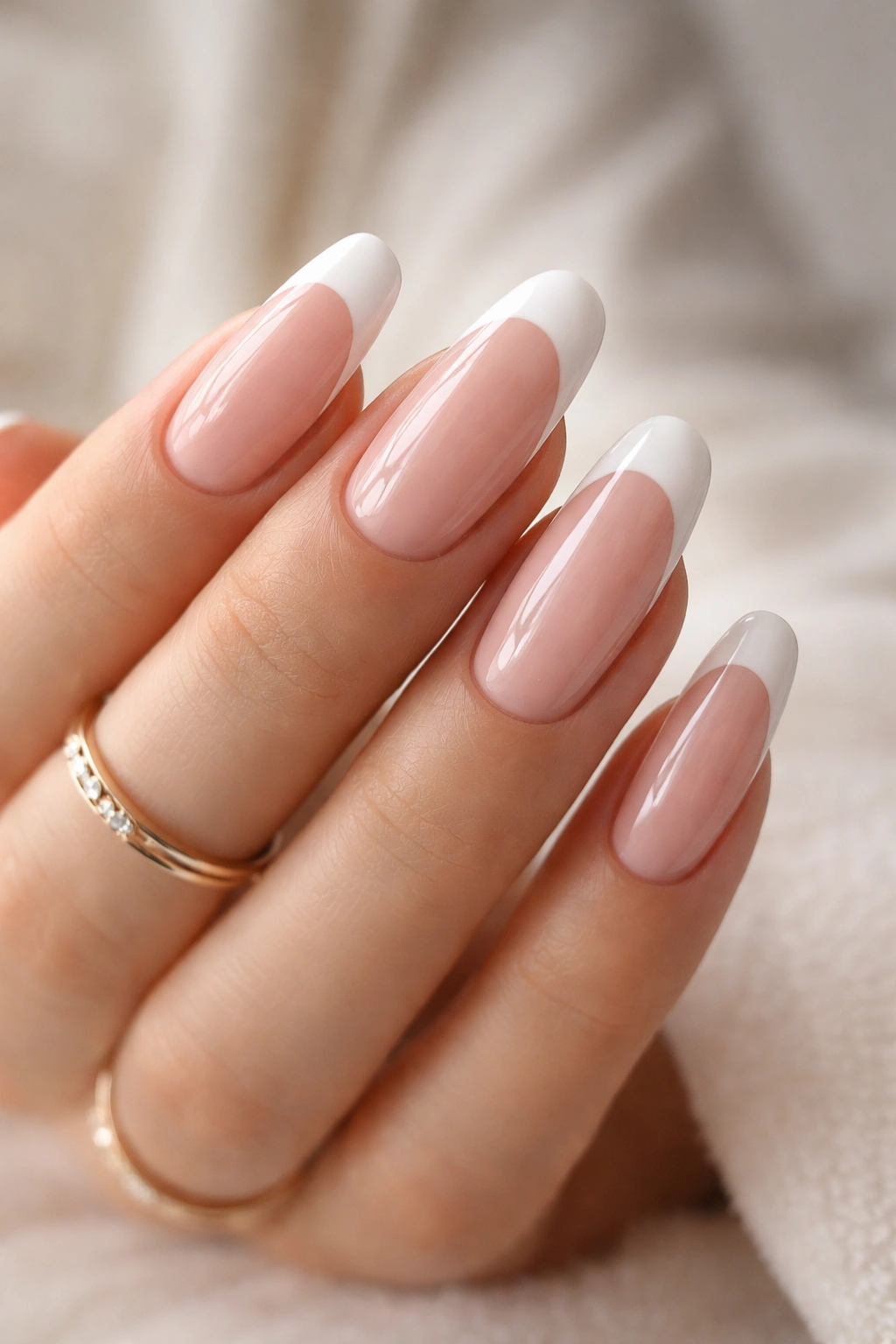 Close-up of long nails with pink base and white tips