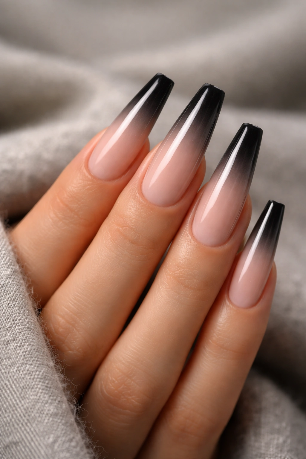 Close-up of coffin nails with light-to-dark ombre and reversed dark tip