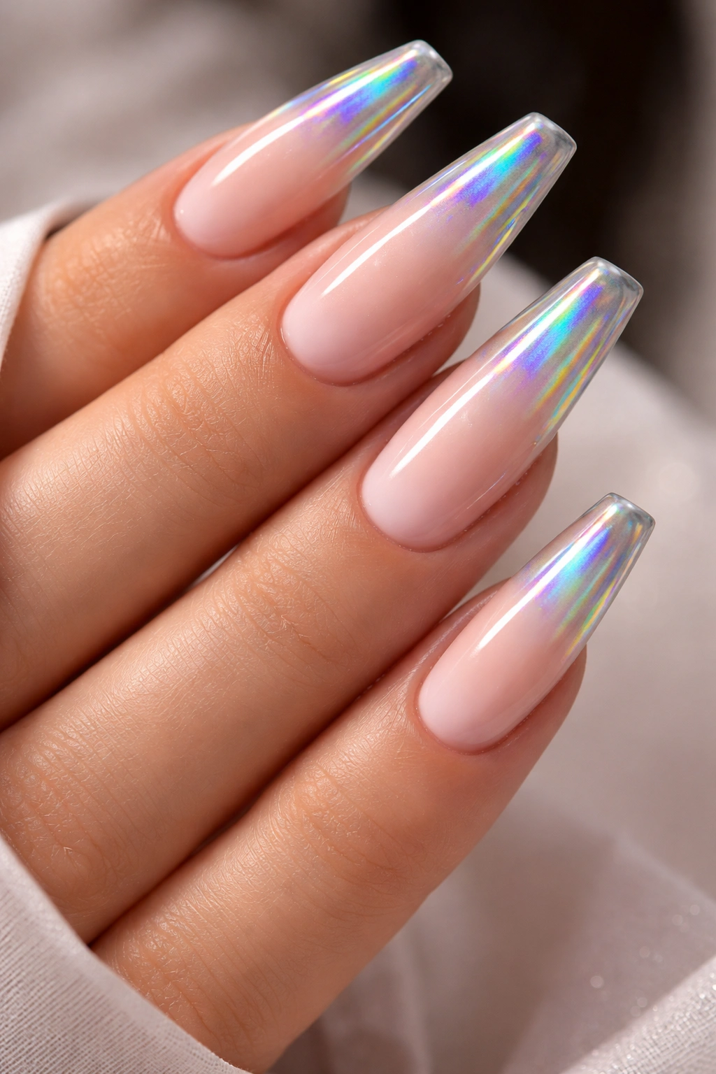 Coffin nails with nude base and holographic tip accents