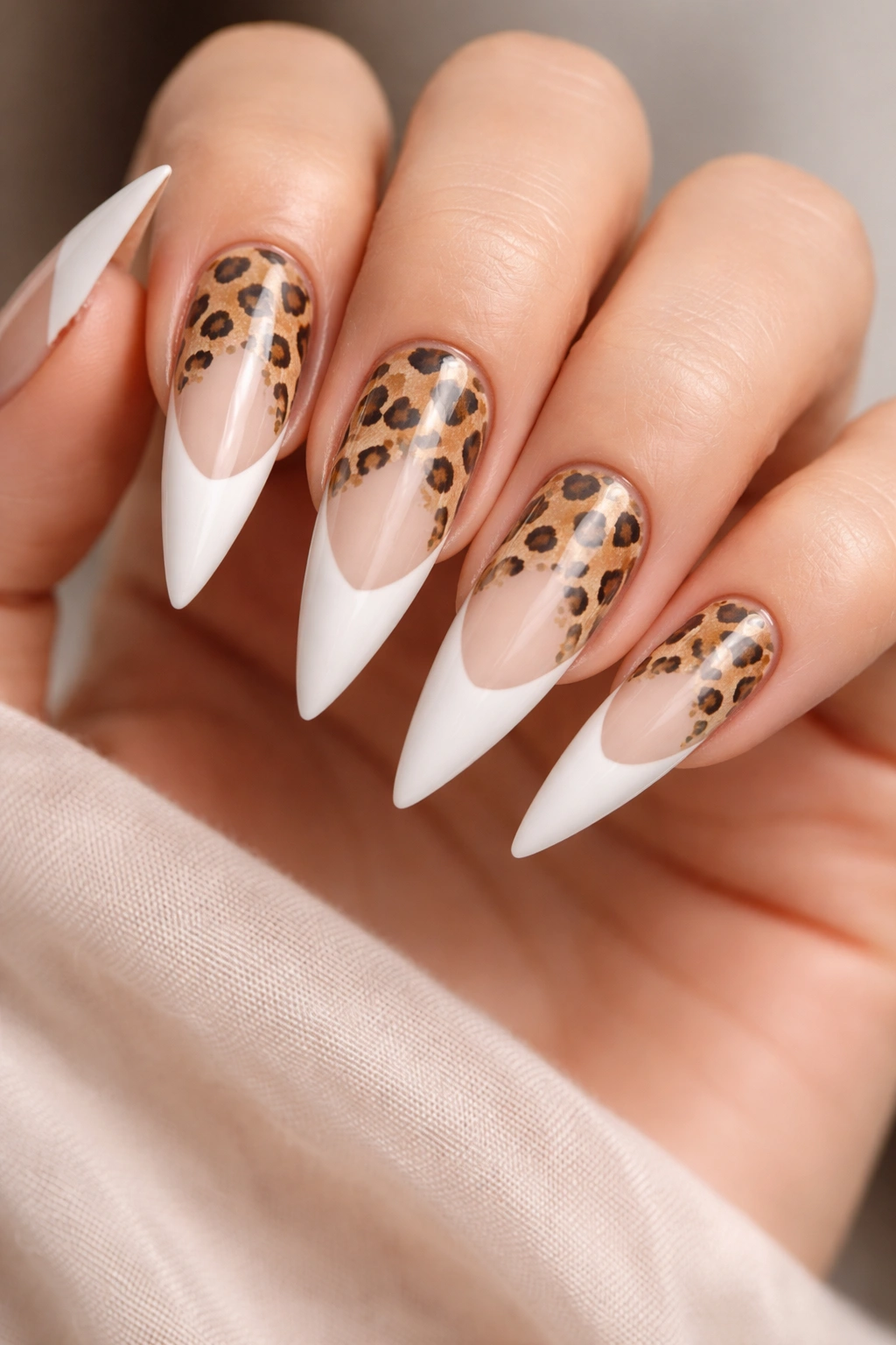 Nude-to-white French tip cheetah stiletto nail with pattern from cuticle to tip