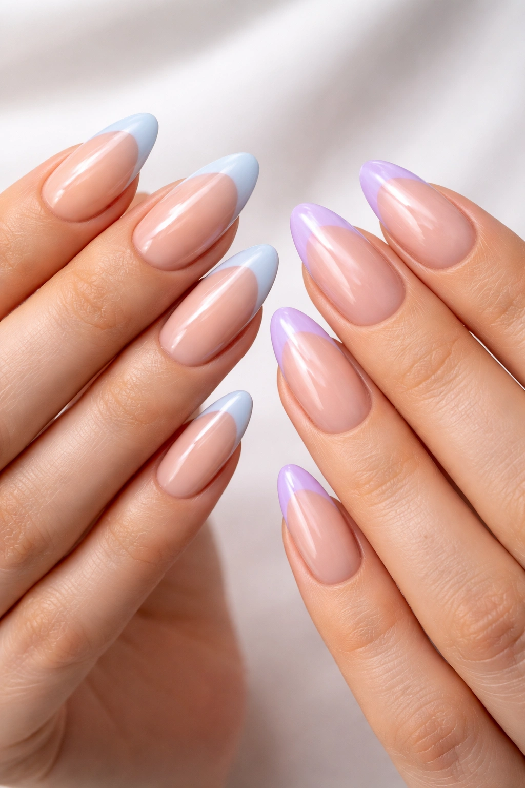 Almond nails with blue and lavender French tips on nude bases