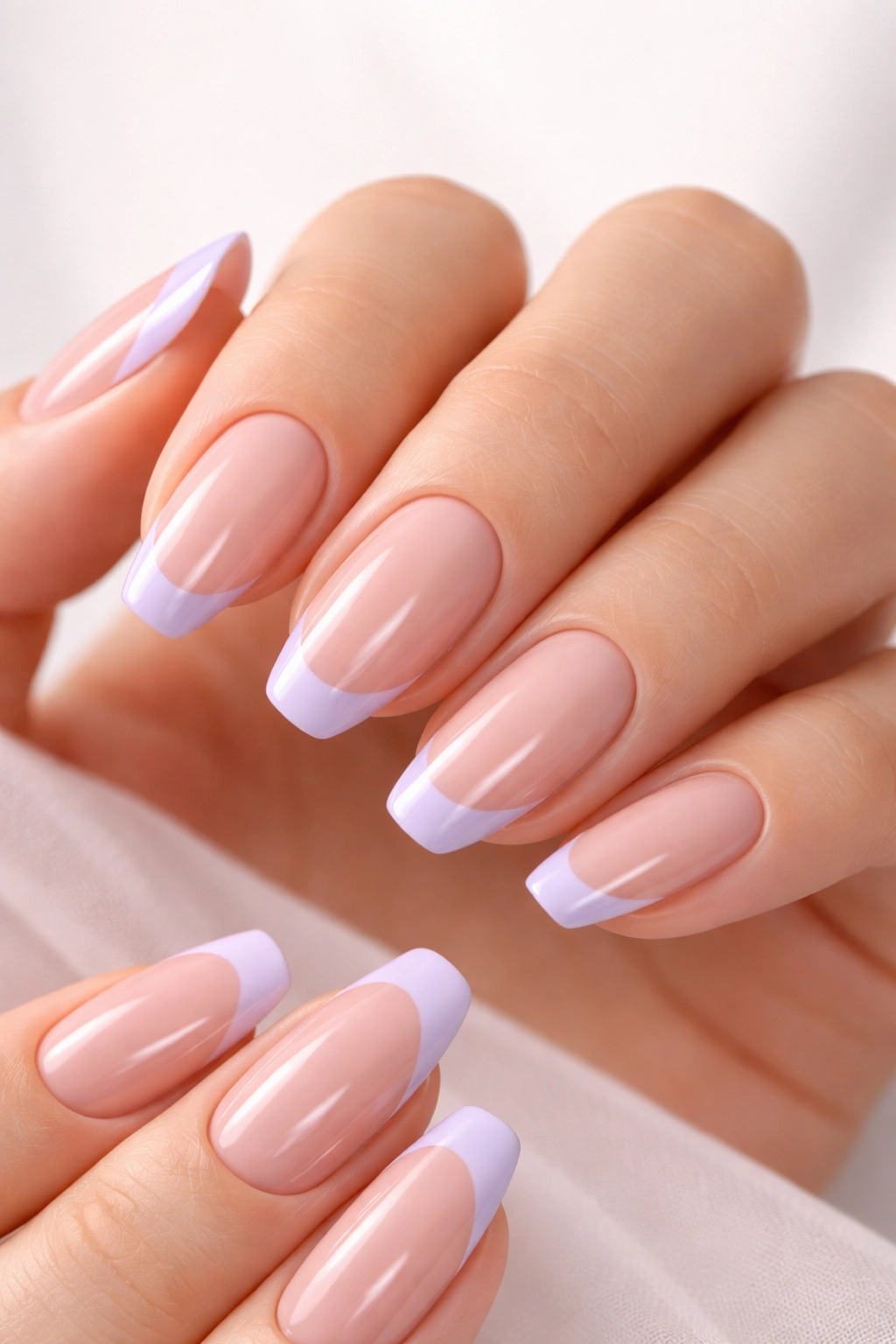 Close-up of nails with lavender-tipped nude manicure in modern French style