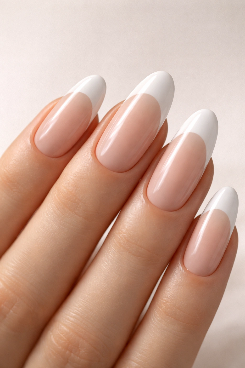 Close-up of long oval nails with ombré white French tips
