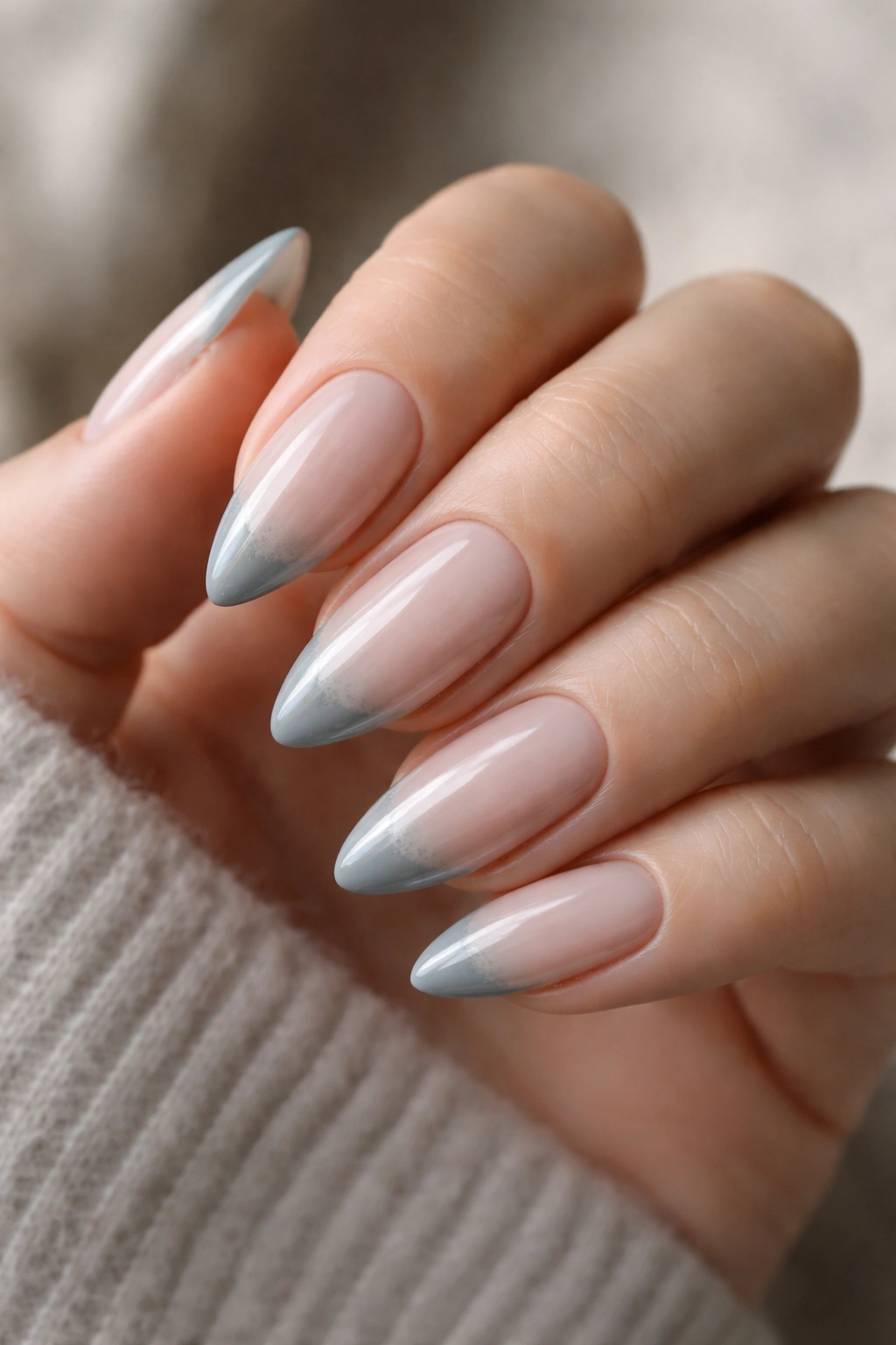 Almond nails with frost gray French tips on sheer base, glossy finish