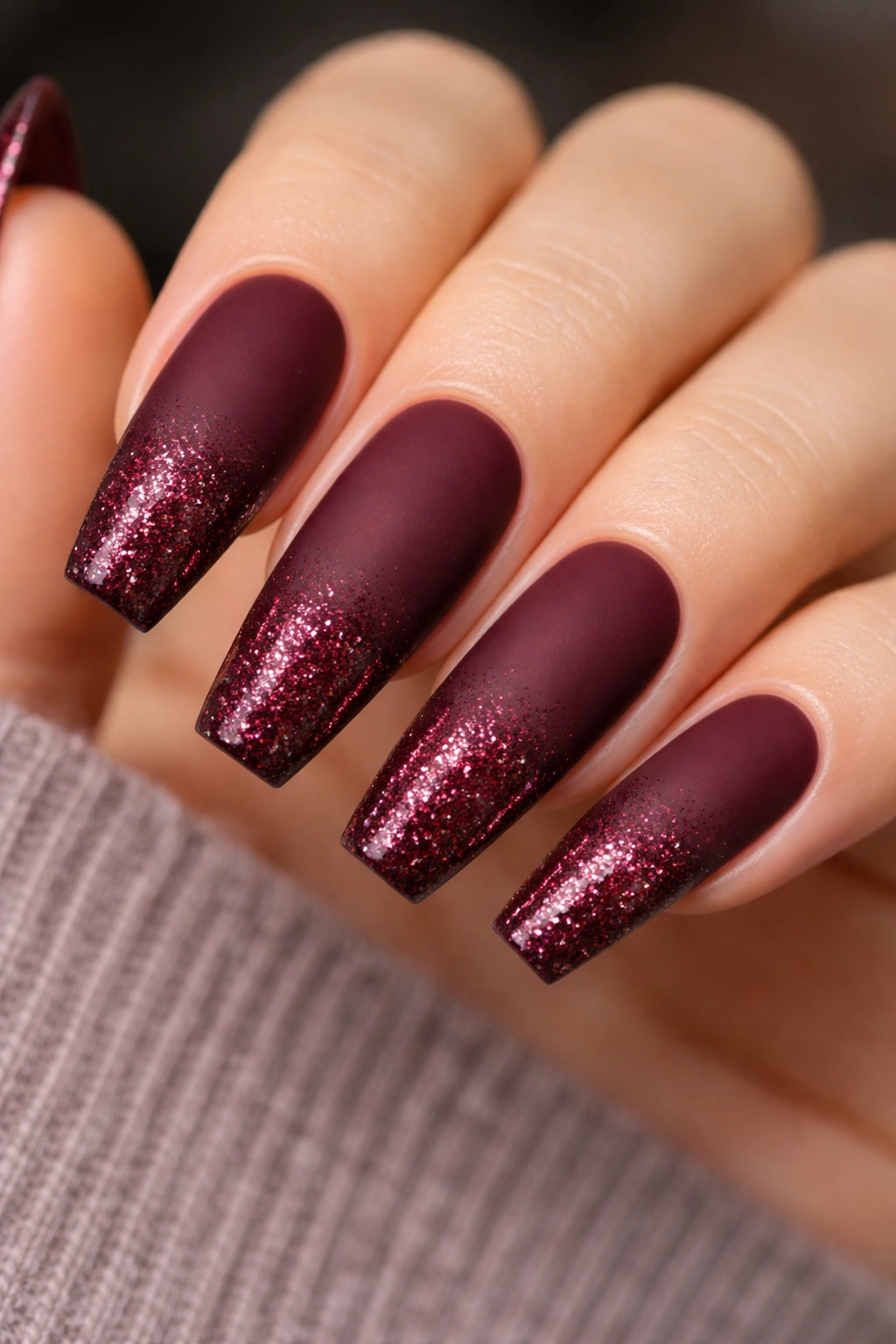 Matte burgundy nails with garnet glitter fade at the tips