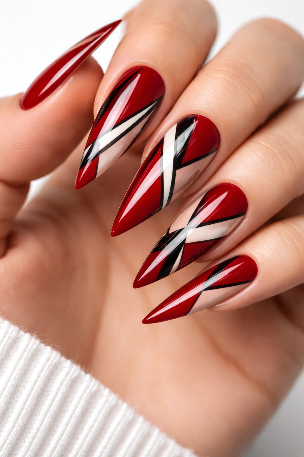 Cherry red stiletto nails with geometric pattern stripes triangles