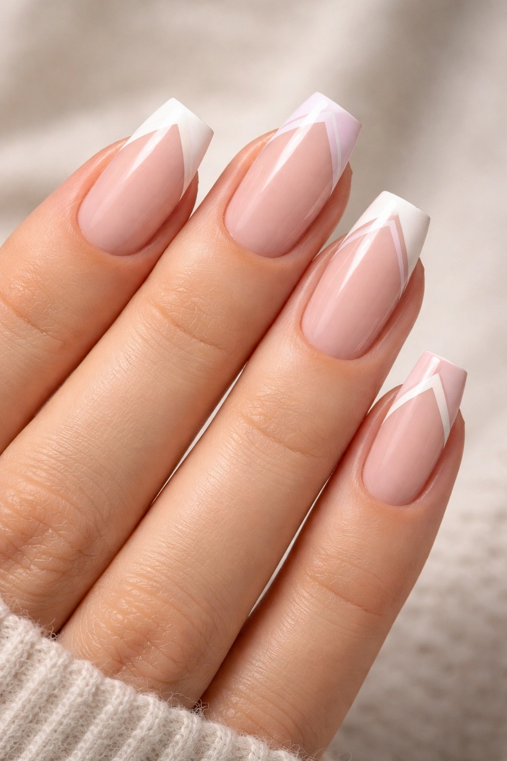 Nails with geometric French tips featuring triangles and chevrons