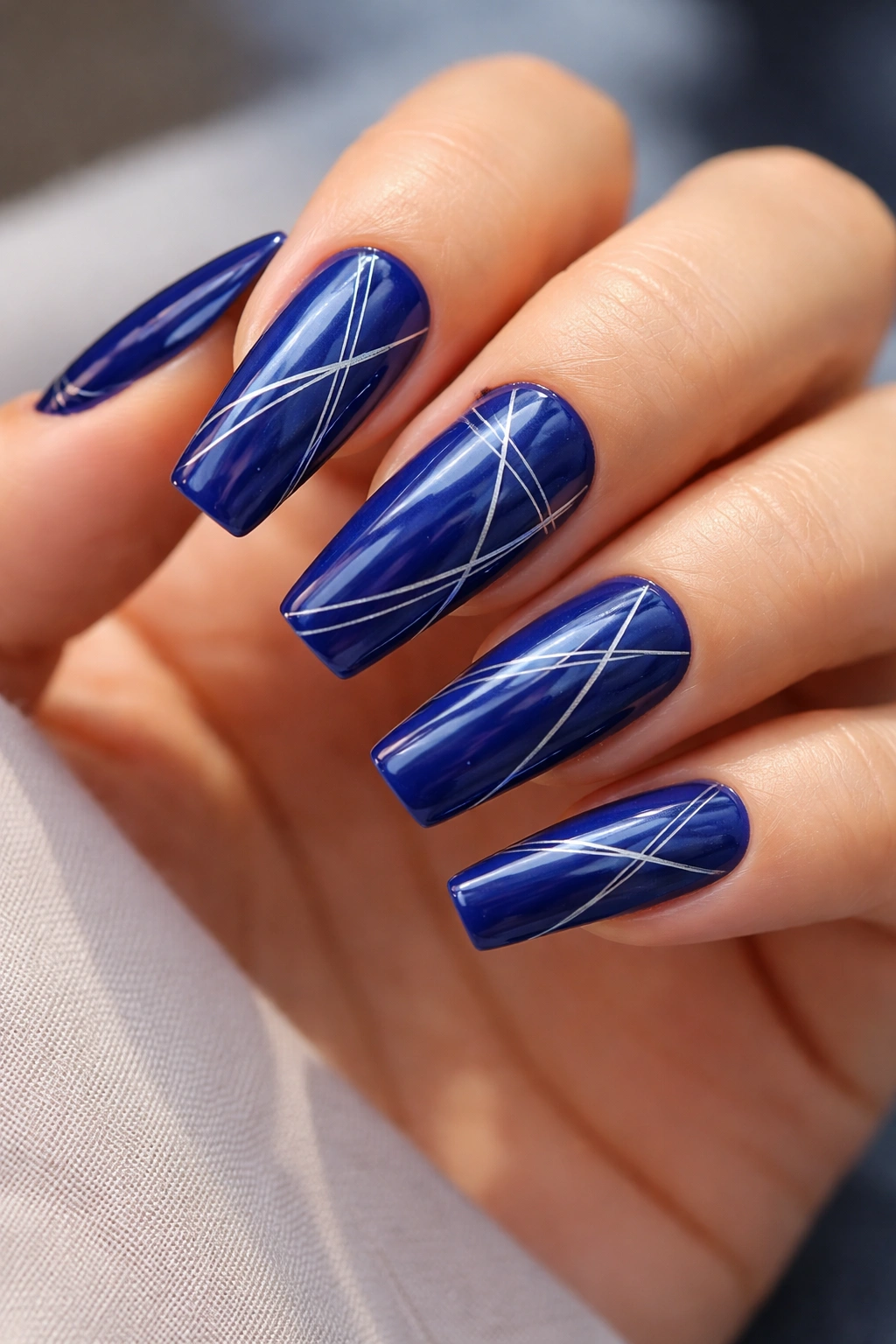 Royal blue coffin nails with delicate geometric line art