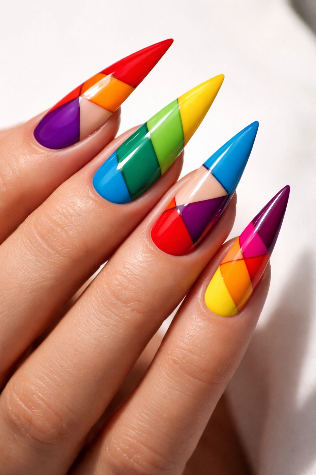 Close-up of rainbow color-block stiletto nails with crisp edges