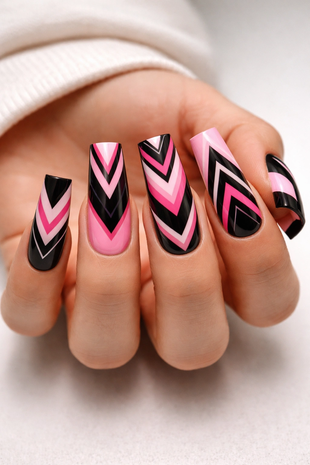 Duck nails with bold geometric black and pink patterns
