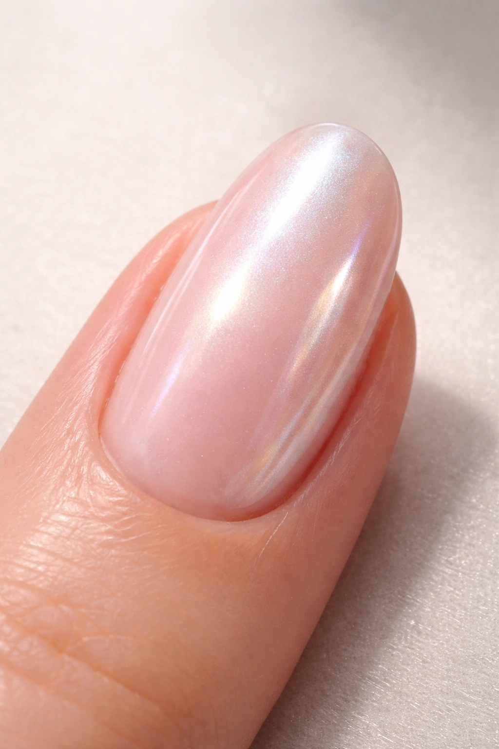Nail with milky pink base and pearlescent chrome finish