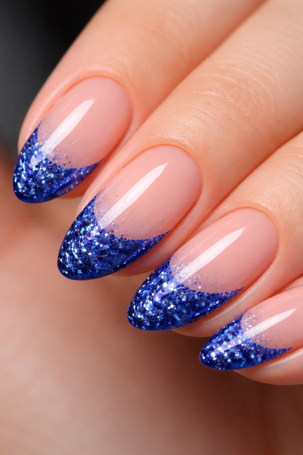 Short almond nail with dense cobalt glitter tip