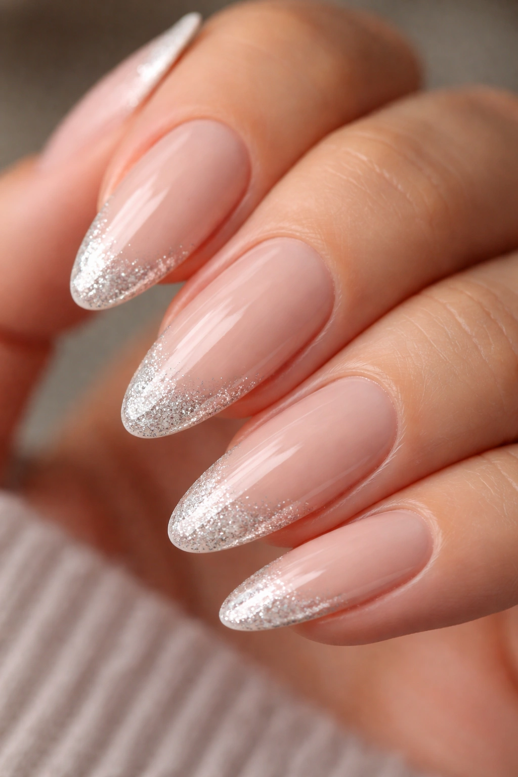 Almond nail with glitter edge on nude base
