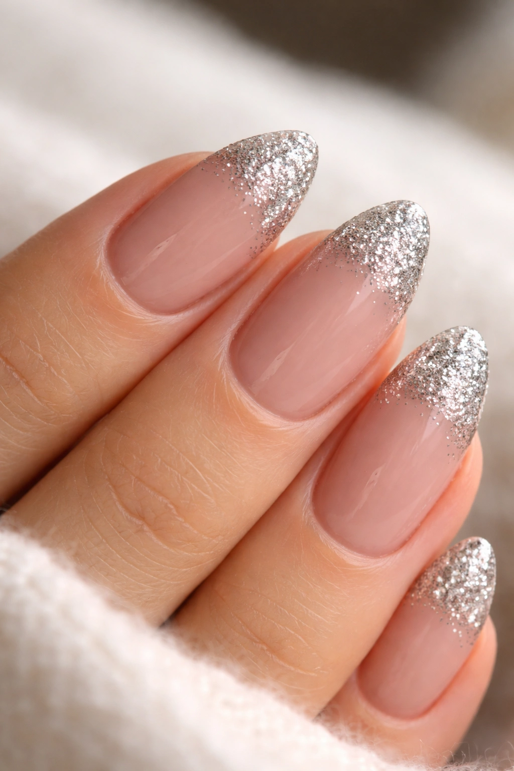 Close-up of short almond nails with dense glitter tips