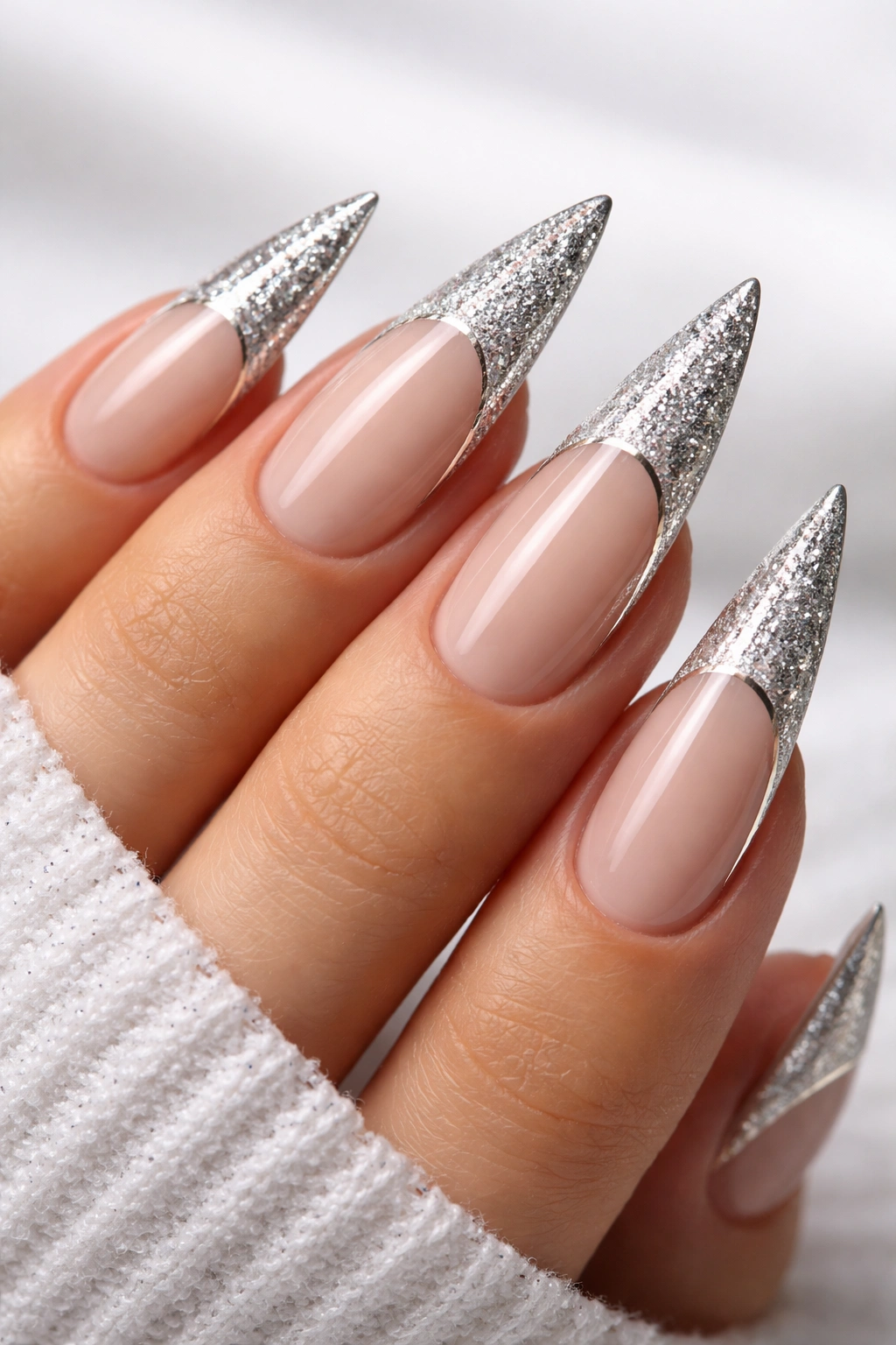 Stiletto nails with glitter-dipped tips and metallic edge