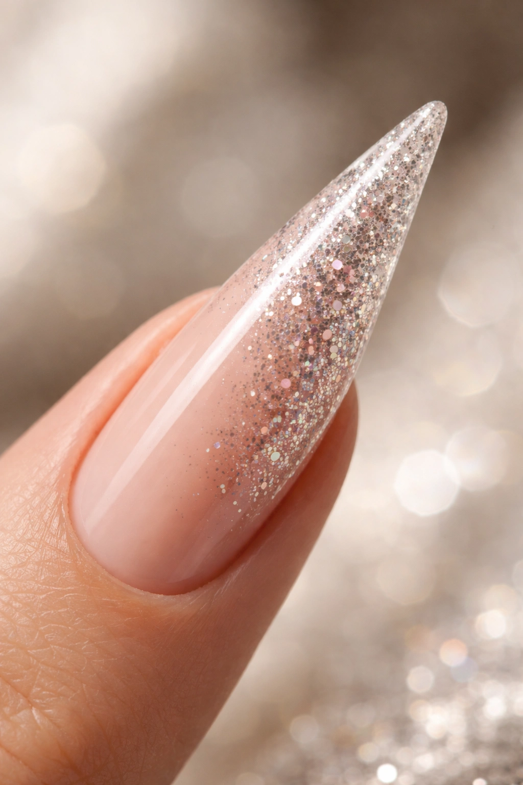 Stiletto nail with encapsulated glitter ombre from base to tip