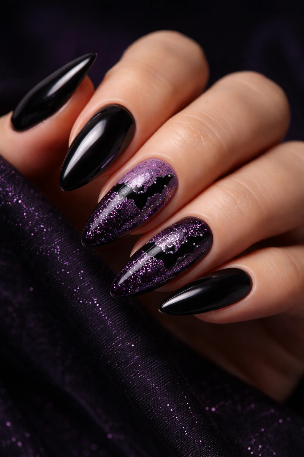 Almond nails black with glittery bat silhouettes on accent nails