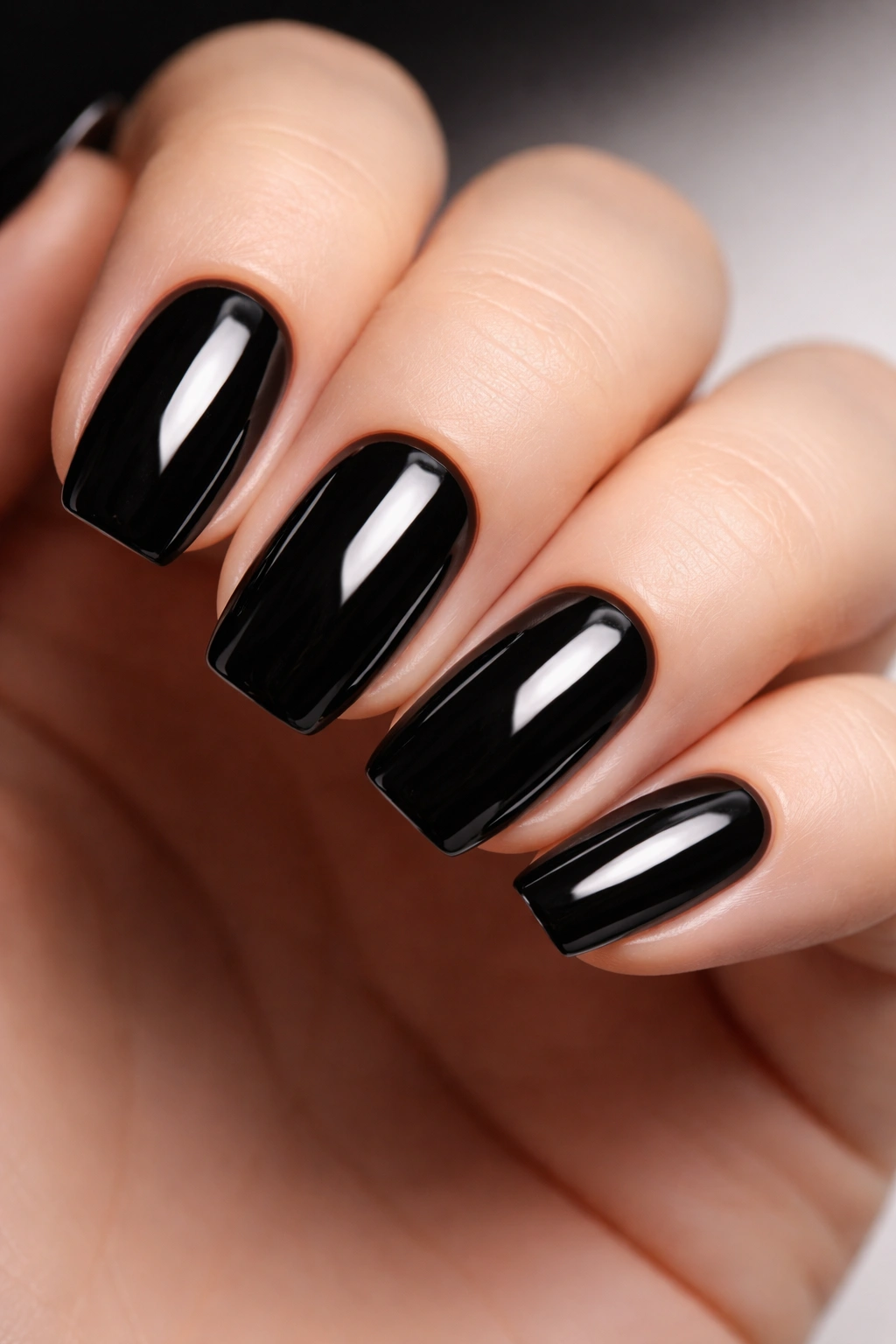 Close-up of hands with Glossy Black nails in high-gloss finish