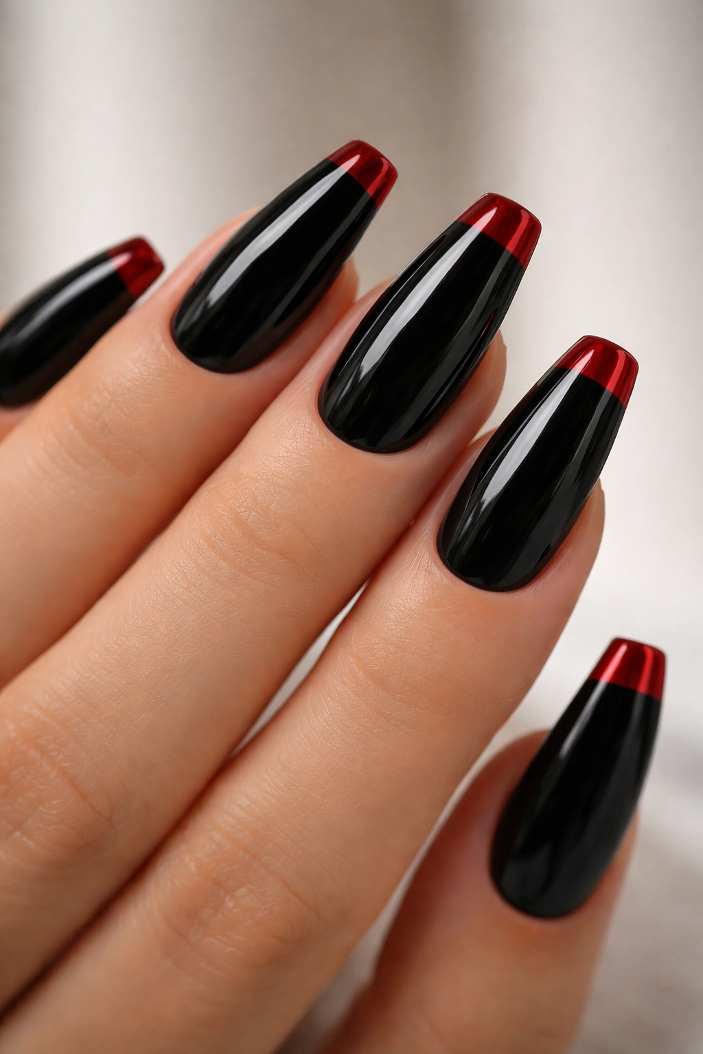 Glossy black nails with deep red French tips on ballerina nails