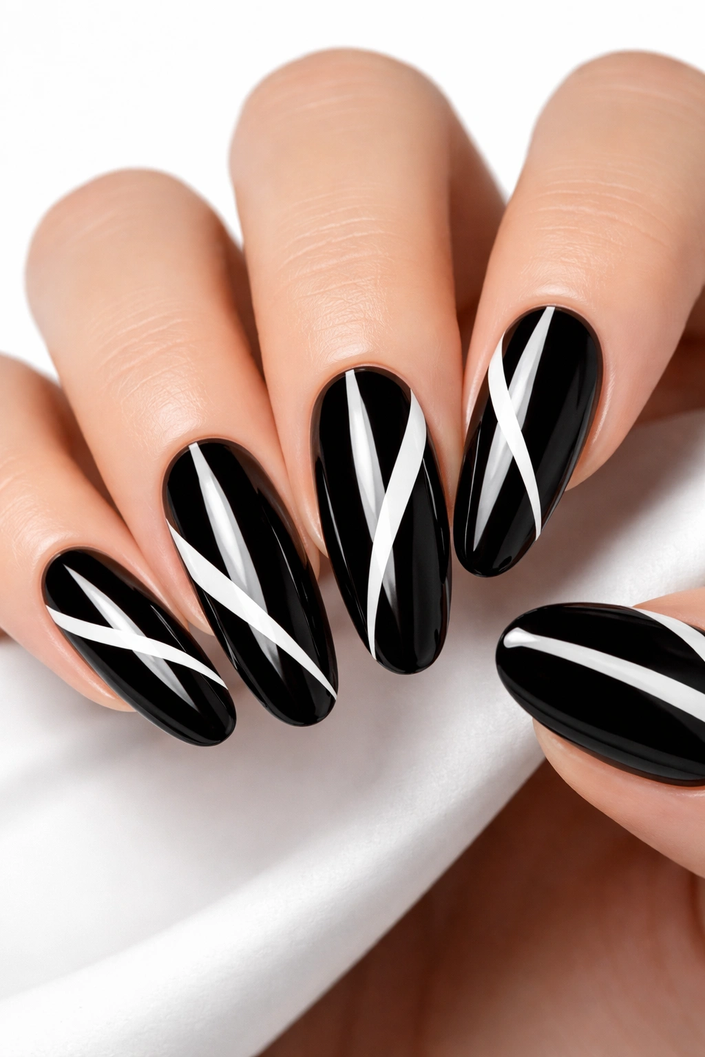 Glossy black nails with white negative-space stripes