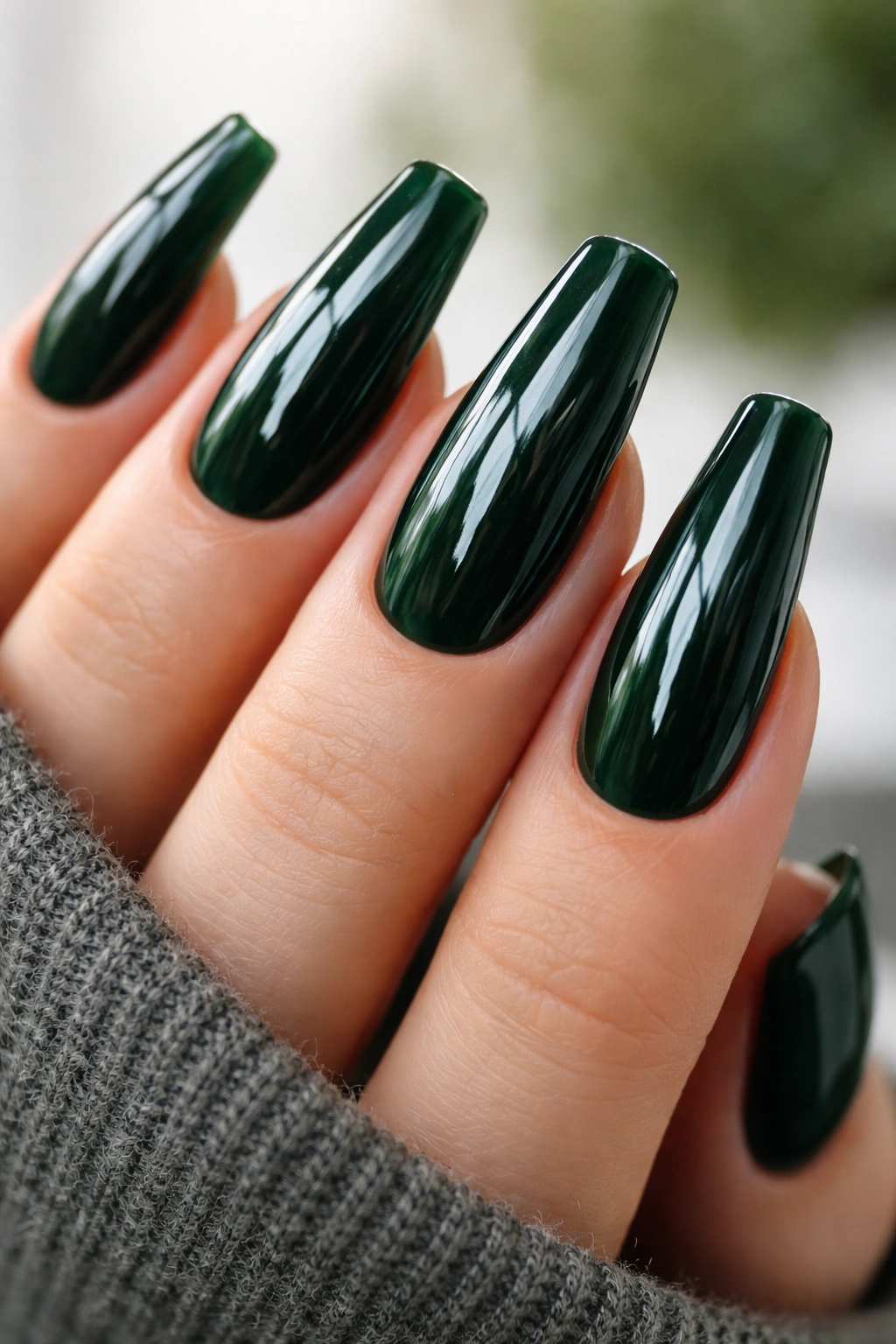Glossy dark green ballerina nails under natural daylight