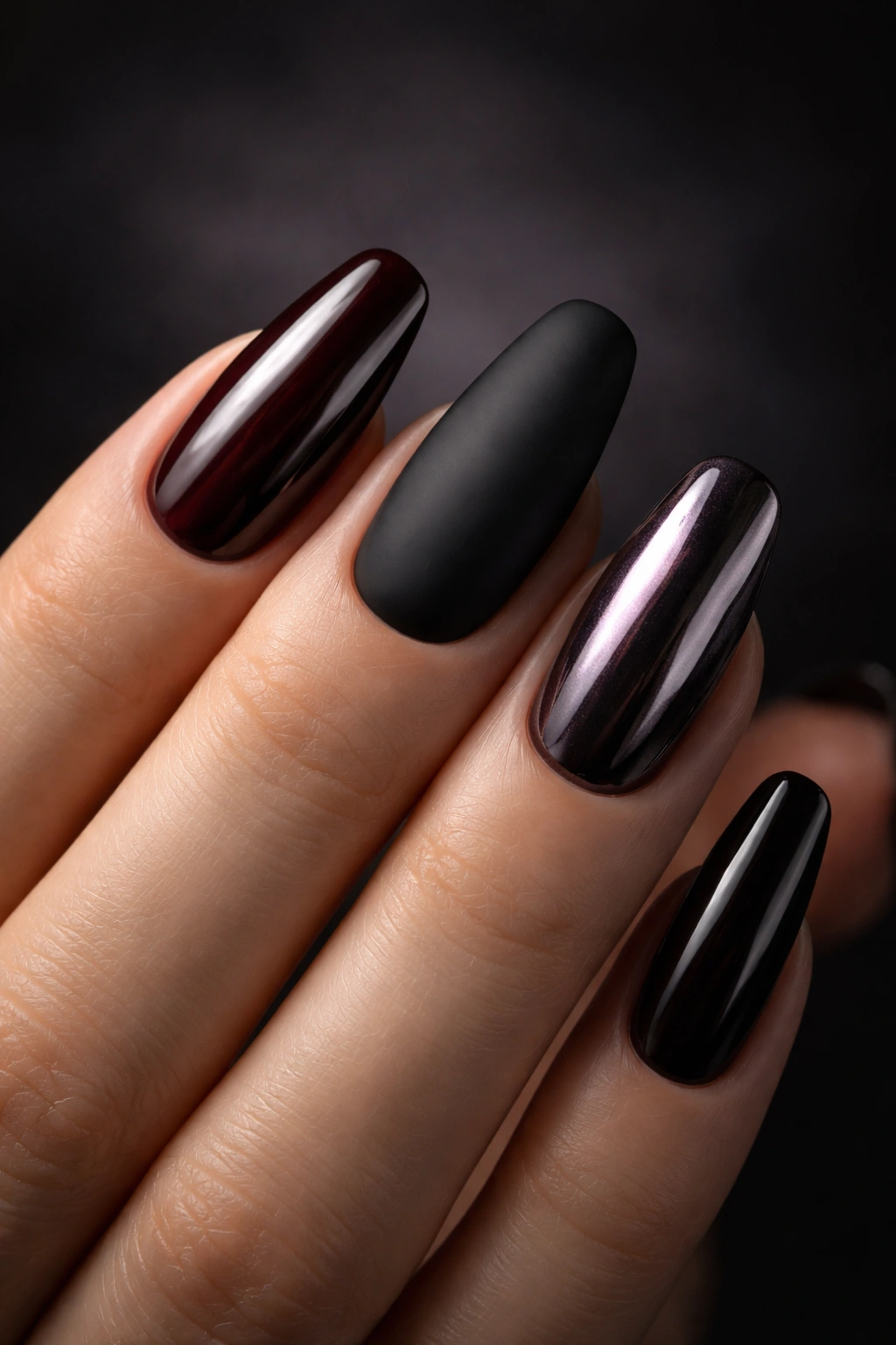 Manicure showcasing glossy, matte, and chrome finishes on dark tones