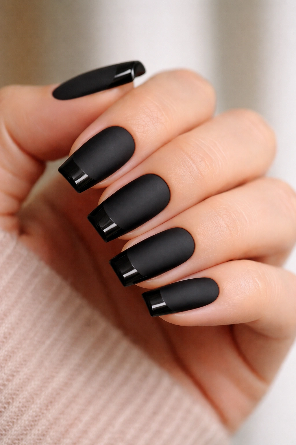 Matte black nails with glossy black tips on a clean base.