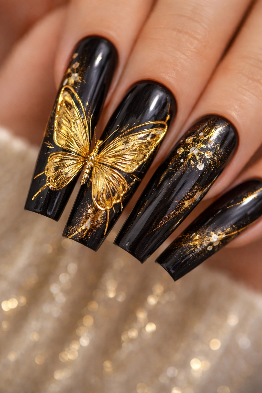 Close-up of coffin nails with metallic gold butterfly design