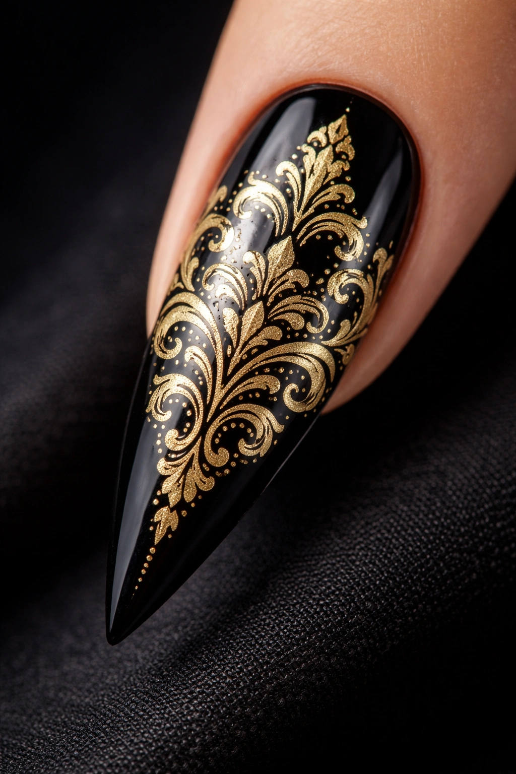 Gold damask pattern on black stiletto nail