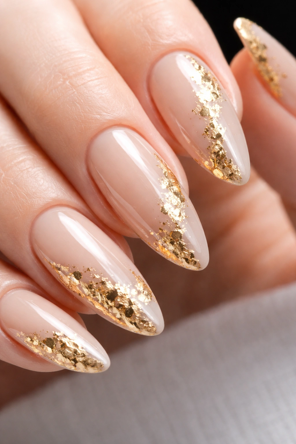 Almond nail with gold foil flakes on nude base