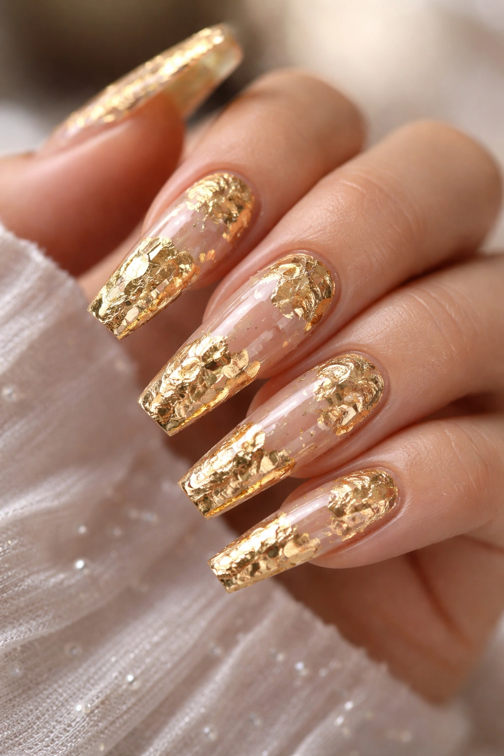 Coffin nails with gold foil applied on a clear nude base