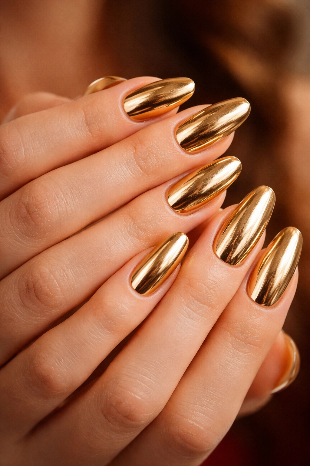Close-up of metallic gold nails with a reflective finish