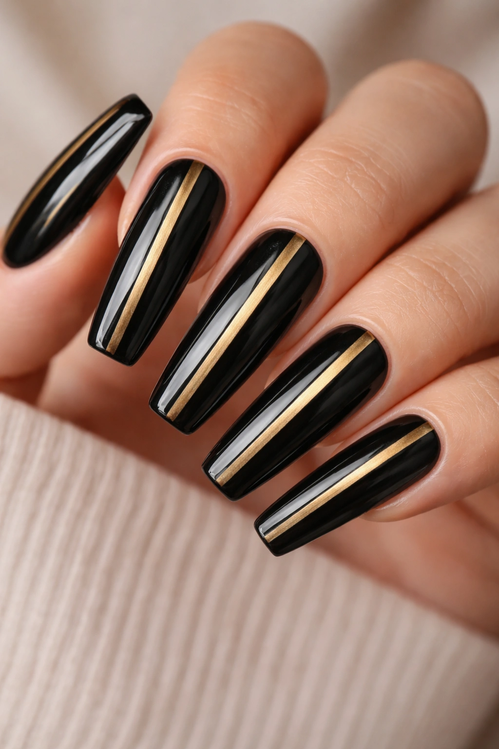 Black nails with vertical gold stripes
