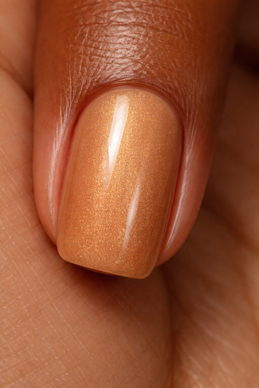 Golden honey fingernail with shimmer close-up