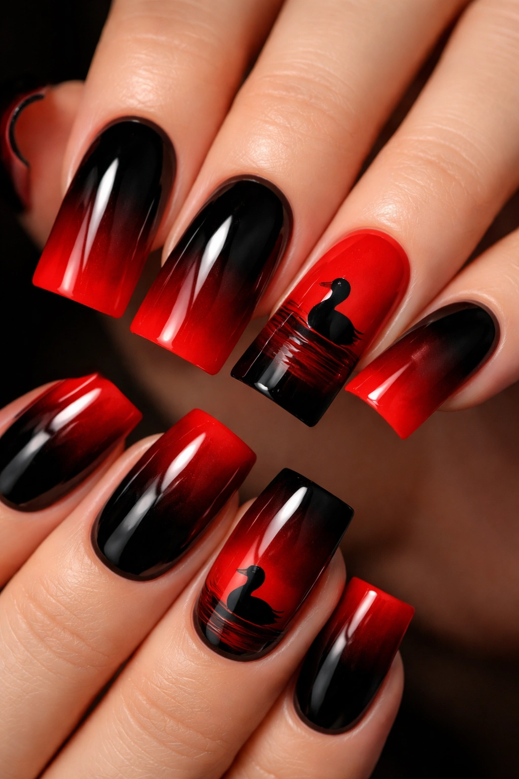 Gradient black to red nails with duck silhouette at transition
