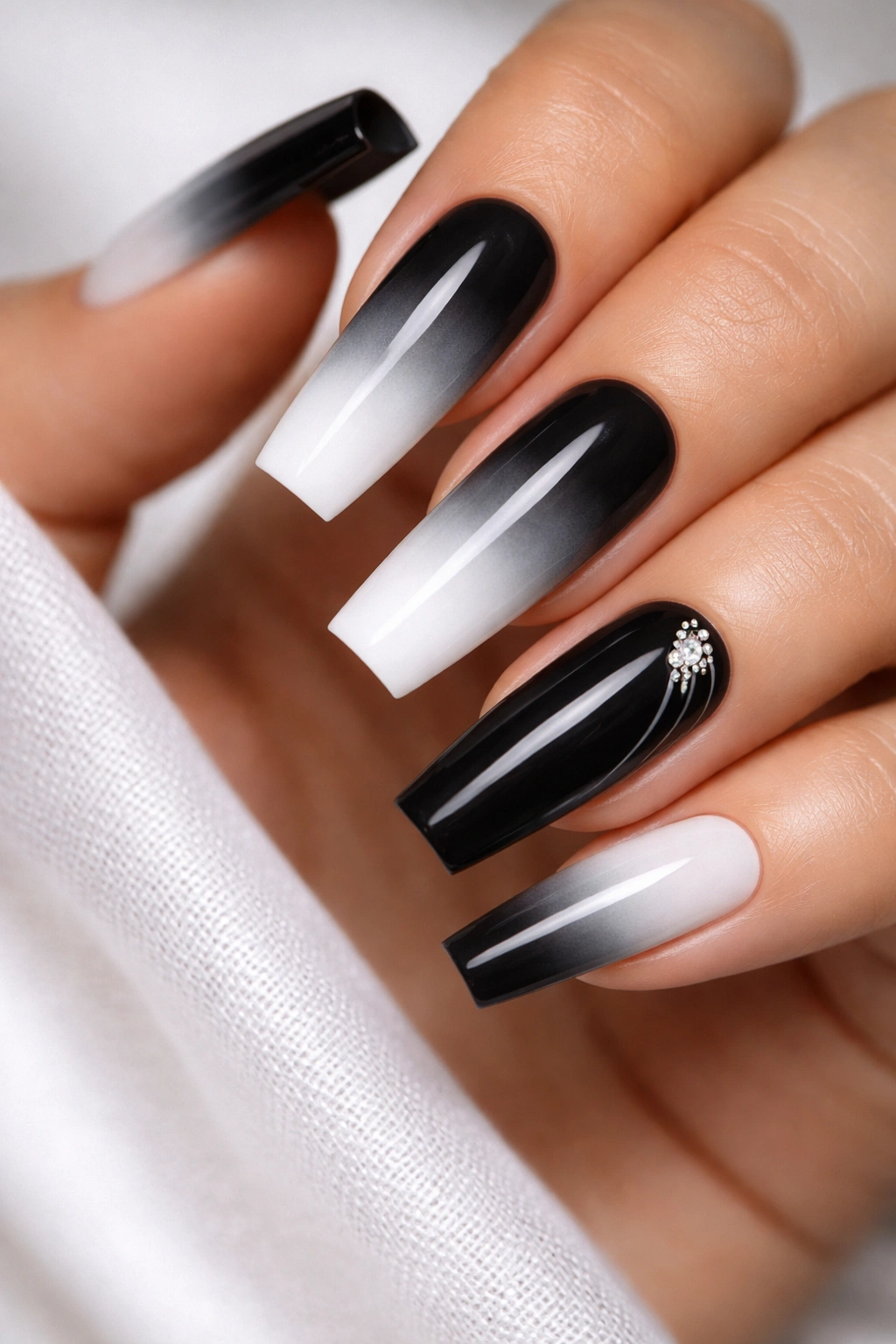 Close-up of coffin nails with black-to-white gradient and a solid black accent nail.