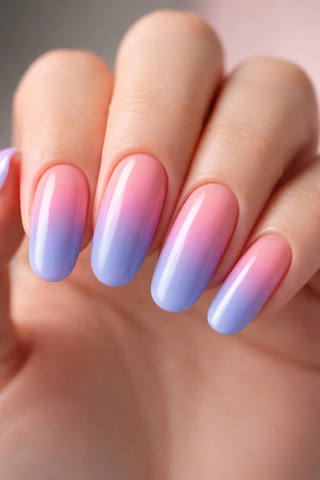 Close-up of long round nails with a smooth two-color gradient fade