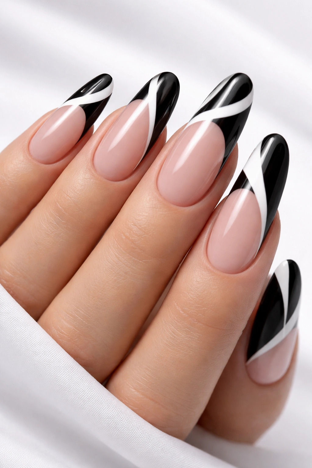 Nails with black and white graphic tips on rounded nails