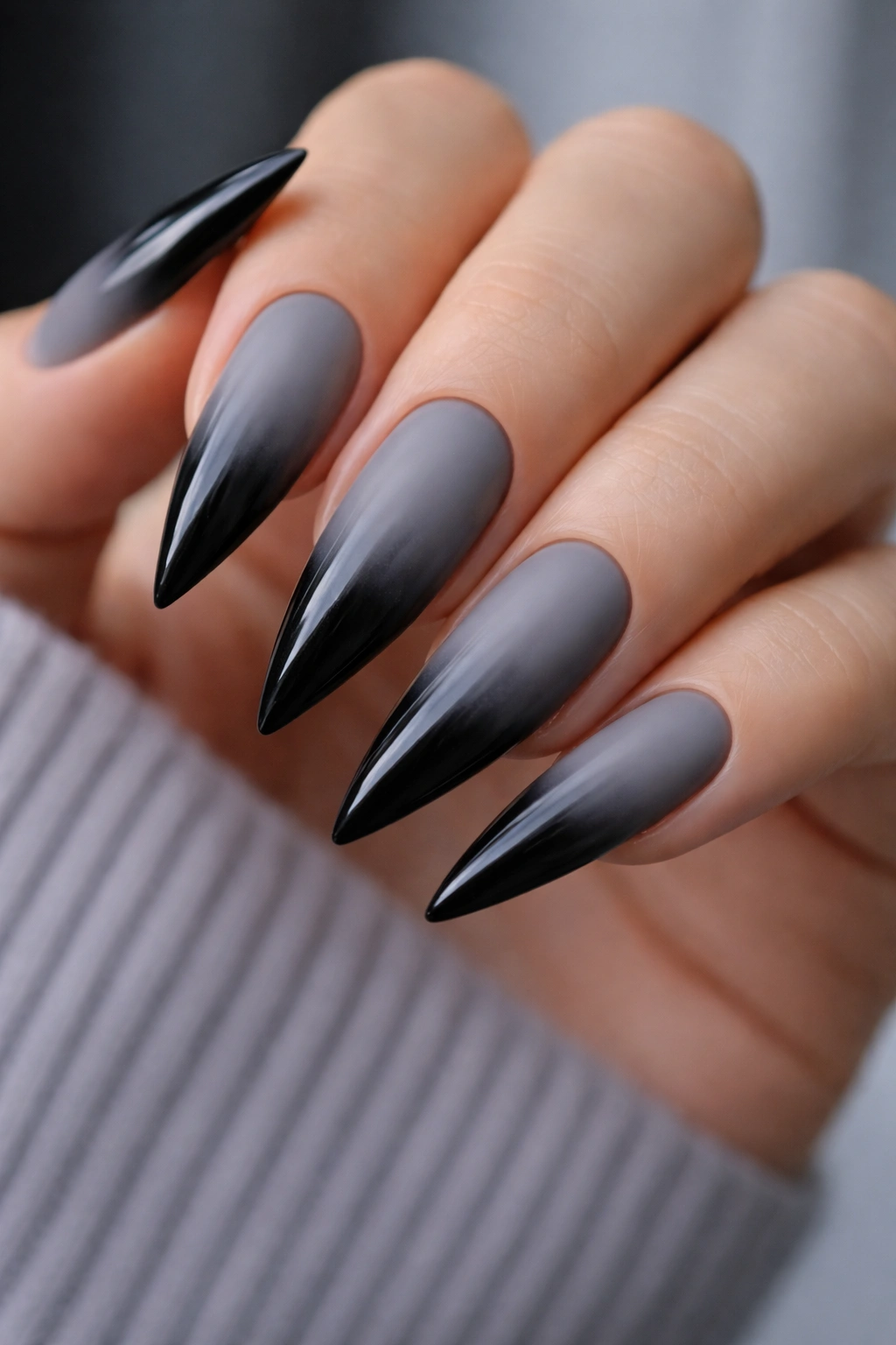 Close-up gray to black ombre stiletto nails