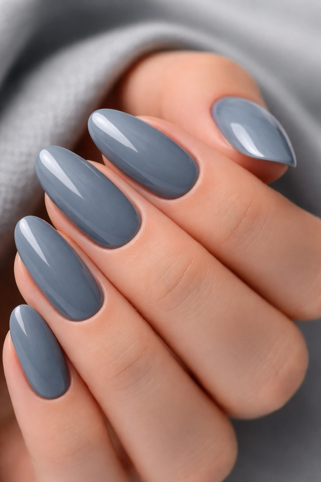 Close-up gray-blue nails with glossy finish