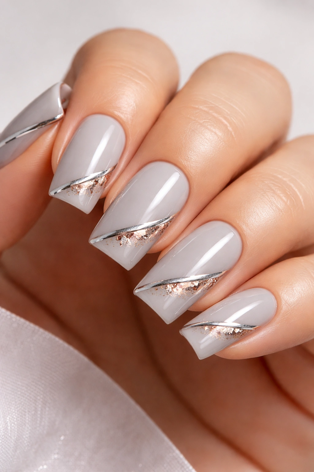 Soft gray nails with metallic details on soft square nails