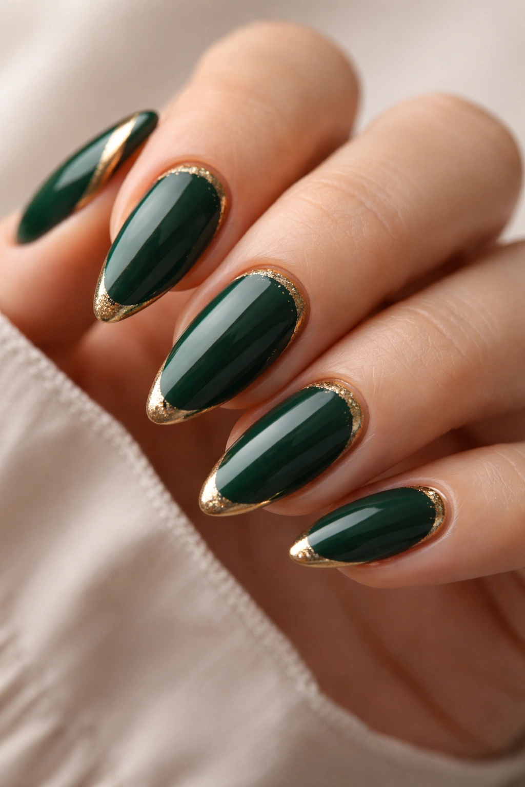 Almond nails with forest green and gold accents.