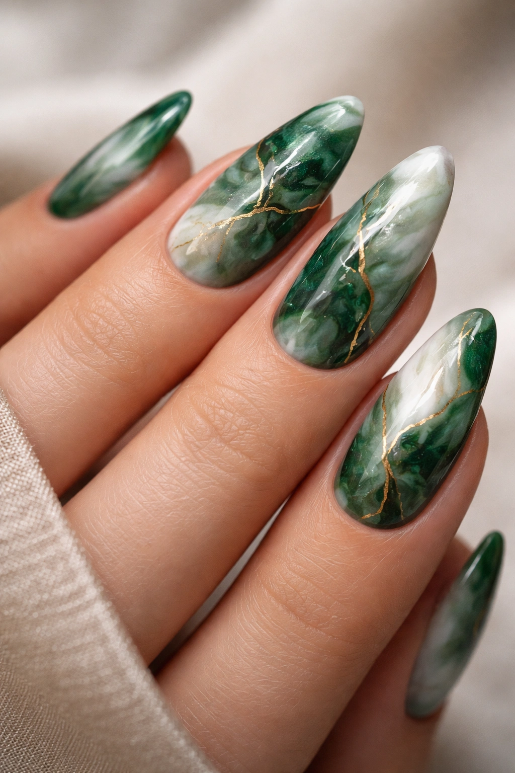 Green marble almond nails with white swirls and gold vein