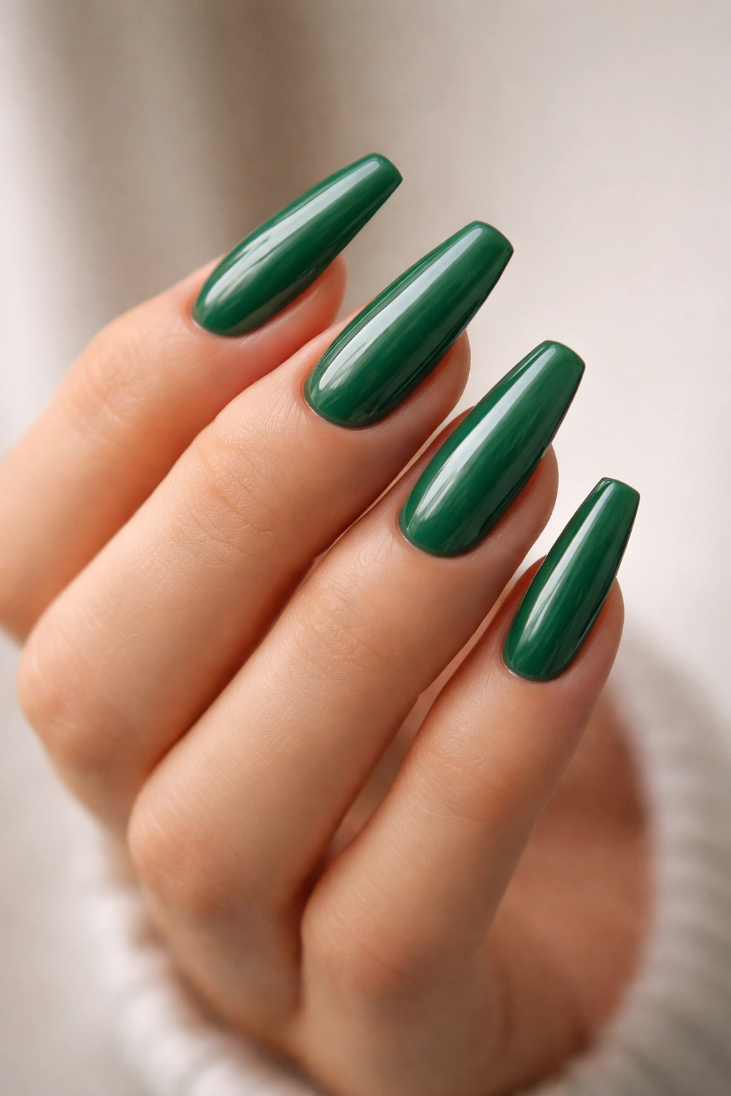 Close-up of green ballerina nails with balanced taper and flat tips