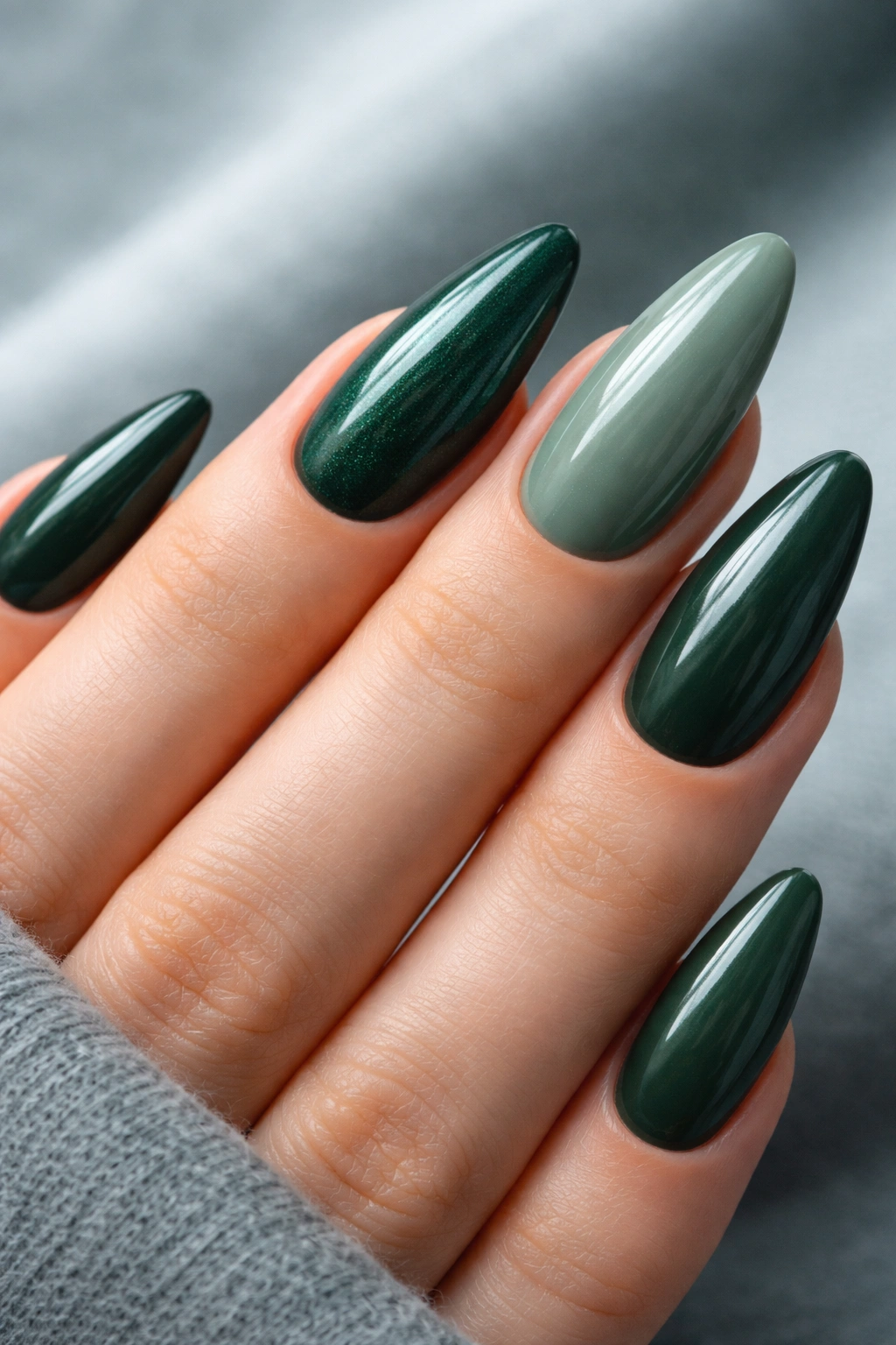 Close-up of deep green nails in forest and emerald tones