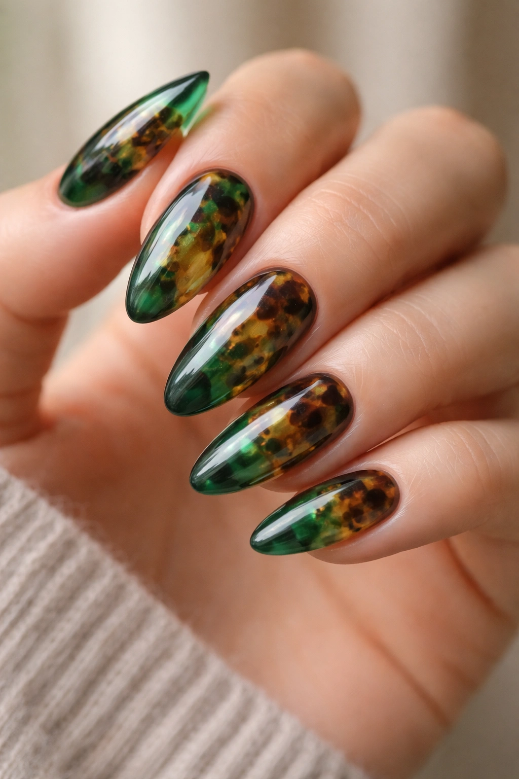 Tortoiseshell almond nails with green hues and translucent patches
